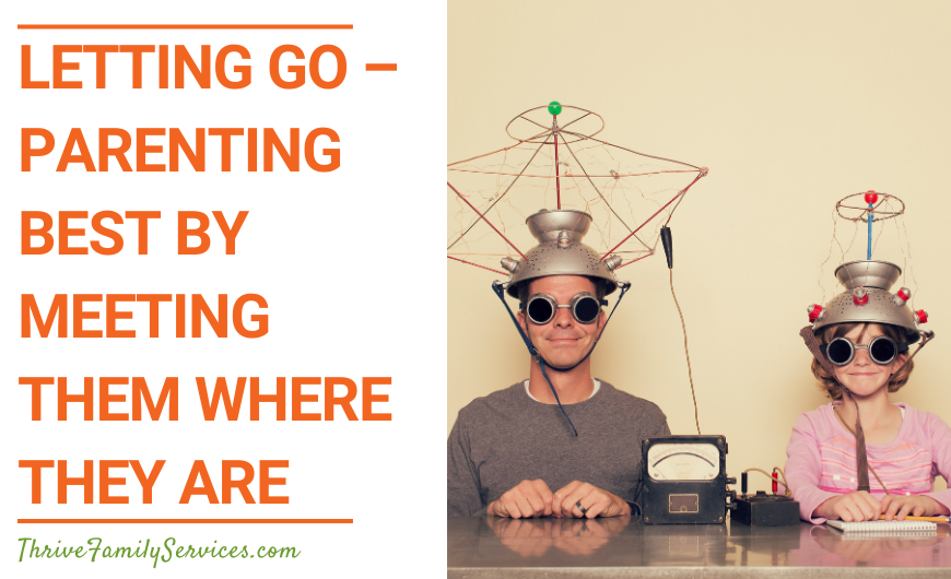 Orange text that reads "Letting Go - Parenting Best by Meeting Them Where They Are" next toa photo of a man and a child sitting next to each other wearing zany helmets. | Aurora Parent Counseling