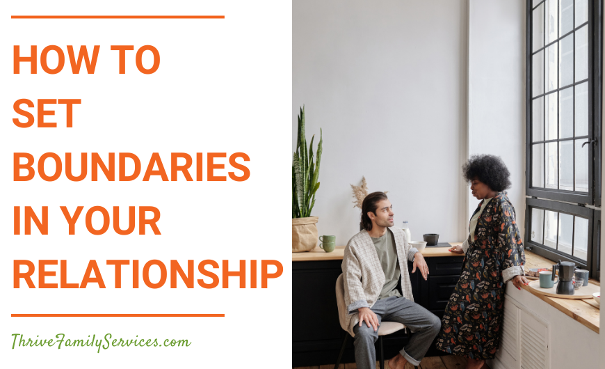 Orange text over a white background that reads "How to Set Boundaries in Your Relationship" to the left of a photo of a man and a woman in a room in front of a large window. The man, who is white, is seated, while the woman, who is Black, is standing facing him. | Lone Tree Colorado Marriage Counselor