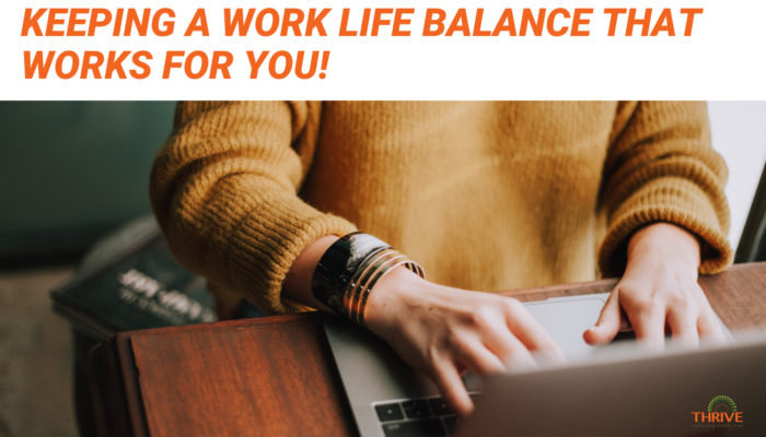 Dark orange text that reads "Keeping a work life balance that works for you!" above a stock photo of a person in a yellow sweater, from the shoulders down, working on a laptop on a wooden table.