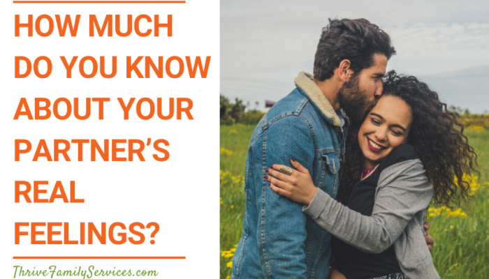 Orange text on a white background that reads "How Much Do You Know About Your Partner’s Real Feelings?" to the left of a photo of a man and a woman outside. They are both wearing jackets and smiling. They are holding each other and the man is kissing the woman on the side of the head. | Greenwood Village Couples Counseling