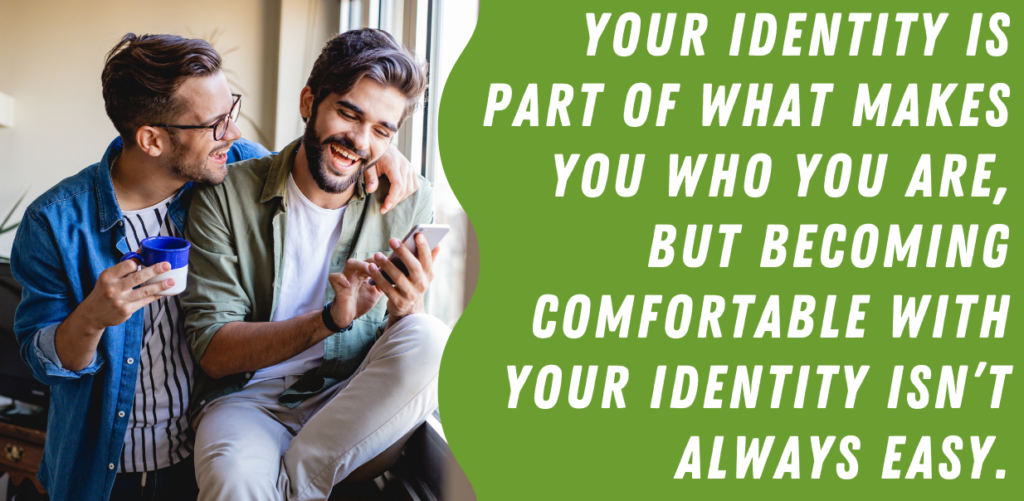 A green graphic with white text that reads "Your identity is part of what makes you who you are but becoming comfortable with your identity isn't always easy." to the right of a photo of two men smiling and looking at a phone together. Their arms are around each other. | LGBTQ Therapy For Individuals and Couples Centennial Colorado