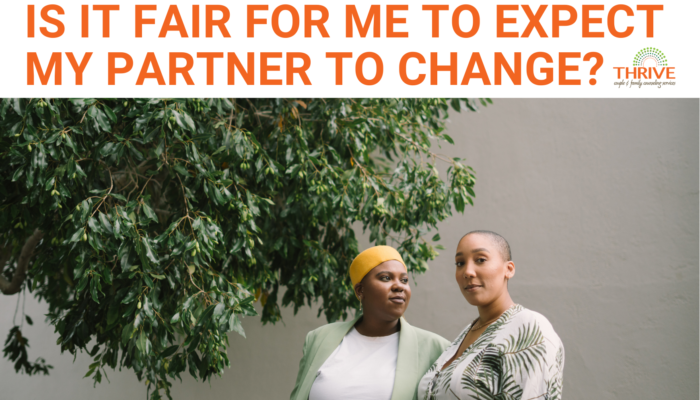 A graphic that reads "Is It Fair for Me to Expect My Partner to Change?" above a stock photo of two Black women standing together outside in front of a white stone wall. To the left of them is a green leafy tree. | Relationship Counseling Centennial Colorado