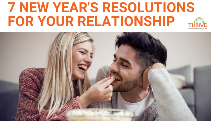 A graphic that reads "7 New Year's Resolutions for Your Relationship" above a stock photo of a couple laying on the floor and eating popcorn while smiling at each other. | Couples Counseling in Centennial
